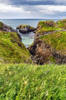 Narrow suspension bridge for walkers on rocky coast, Rope Bridge Carrick-a-Rede, footpath,