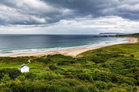 Dune landscape White Park Bay, Whitepark Bay with sandy beach, dramatic rain clouds, coastline,