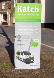 Sign for Katch On-demand electric taxi bus service, Wickham Market, Suffolk, England, UK