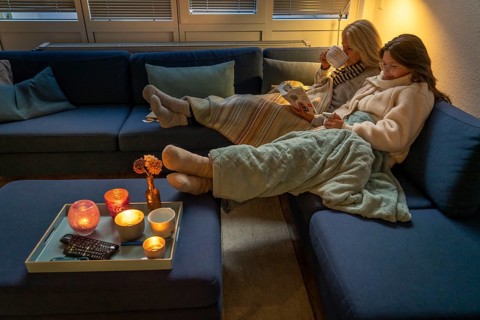 Symbolic image energy saving, cold winter, energy crisis, cold flat, mother and daughter lying on