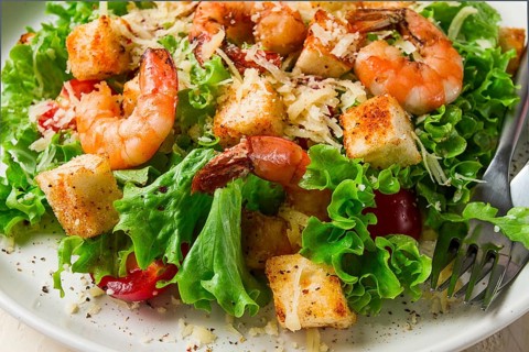 Caesar salad, with shrimp, on a white background, homemade, no people