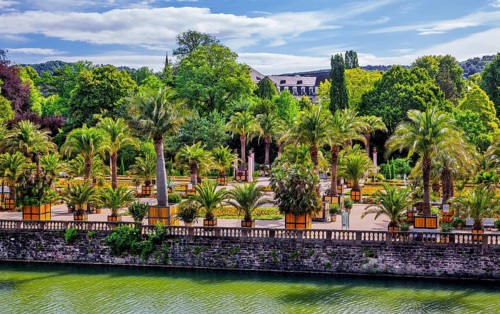 Castle moat with palm garden in the spa gardens, the largest outdoor palm garden north of the Alps,