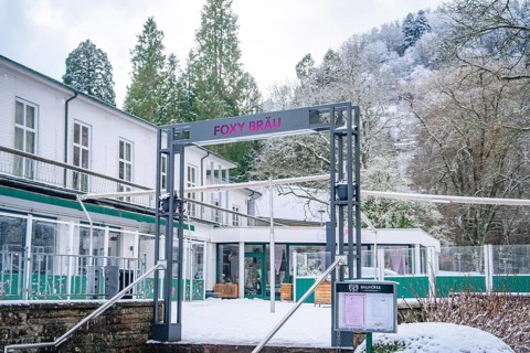 Facade of a modern restaurant in a snow-covered forest landscape, Bad Wildbad, Black Forest,