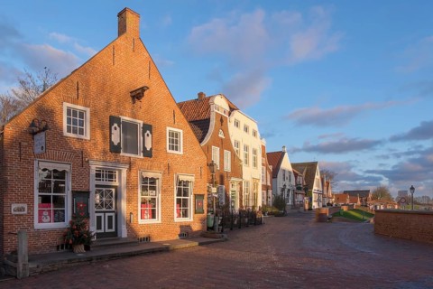 Historic brick houses at the harbour, Greetsiel, Krummhörn, East Frisia, Lower Saxony, Germany,
