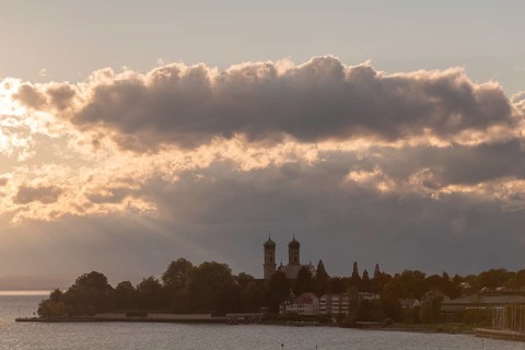 Baroque castle church, double tower, onion dome, evening light, sunbeams, Friedrichshafen on Lake