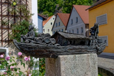Finely crafted bronze sculpture of an old travelling ship on a pedestal next to flowers, Kallmünz,