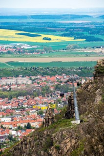View from the Hexentanzplatz to the cable car, the town of Thale and the Harz foreland with fields