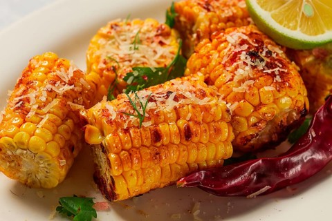 Grilled corn with spices, top view, no people, homemade