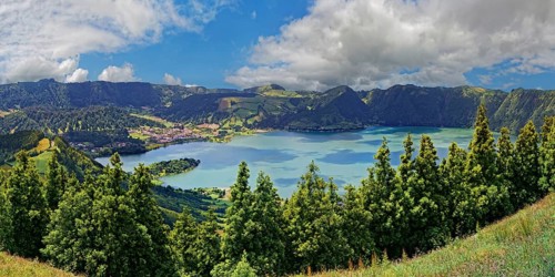 Impressive panorama of the crater lake Lagoa Azul with lush green colours and a blue sky, crater