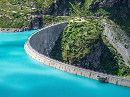 Dam of the Moiry lake, Lac de Moiry, turquoise glacial water, parking lot and restaurant at the