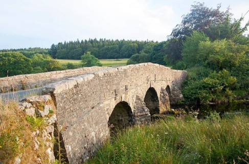 Historic Packhorse bridge at Postbridge, Dartmoor national park, Devon, England crossing the East