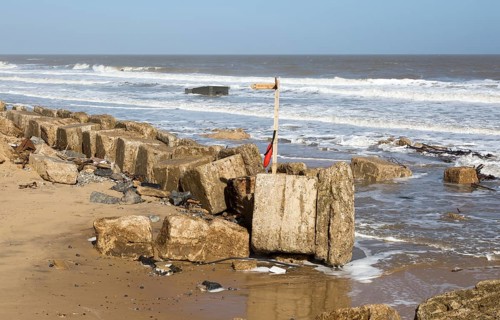 March 20 2018 Hemsby, UK. Coast path sign left abandoned by coastal erosion at Hemsby, Norfolk,