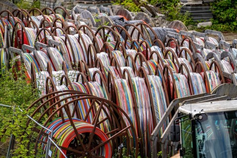 Cable drums with conduits for fibre optic cables, in a storage yard, North Rhine-Westphalia,