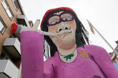 Papier-mâché figure smoking a joint, cannabis legalisation theme, themed float on the Rose Monday
