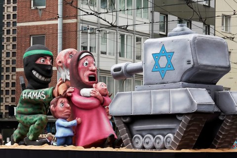 Hamas terrorist hides behind civilians in front of an Israeli tank, papier-mâché figures, satirical