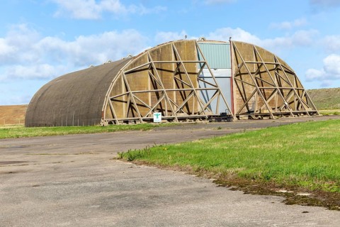 Aircraft hangar for jet fighter military planes, former USAF base, Bentwaters Park, Suffolk,