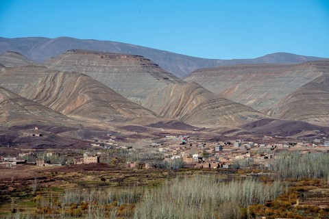 View of Taboulmante with colourful mountains in the background, layered landscape, Gorges du Dades,