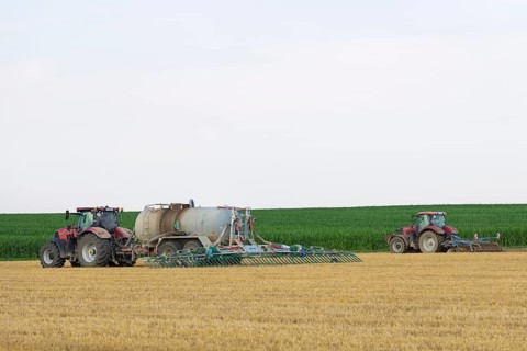 Farmers spread liquid manure on harvested grain field and plough it up, Swabian Alb,