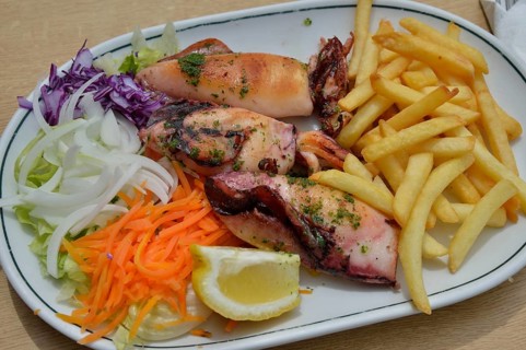 Grilled squid, fries and salad on a plate, Majorca, Balearic Islands, Spain, Europe