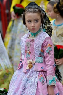 Fallas festival, girl in a traditional costume during the parade in the Plaza de la Virgen de los