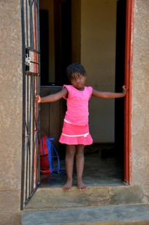 Himba girl in a house in the Himba district of Otuzemba, Otuzemba, Opuwo, Kaokoland, Kunene,