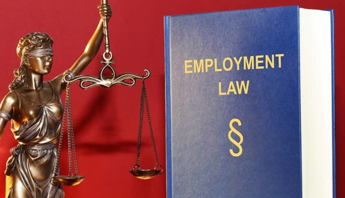 Symbolic image: Reference book Employment law (labour law) and a Justitia