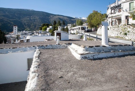 Traditional roofs and chimneys of houses in the village of Capileira, High Alpujarras, Sierra