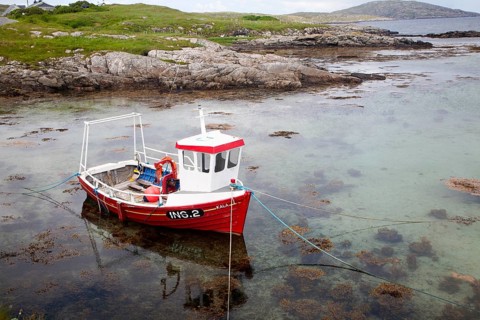 Small fishing boat on the east coast of Barra, Outer Hebrides, Scotland, UK