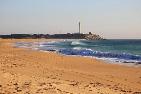 Sandy beach and lighthouse at Cabo de Trafalgar, Cadiz Province, Spain, Europe