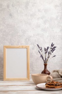 White wooden frame mockup with lavender in ceramic vase, linen textile, cup of coffee and bun on