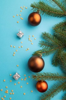 Christmas or New Year composition. Decorations, bronze balls, fir and spruce branches, on a blue