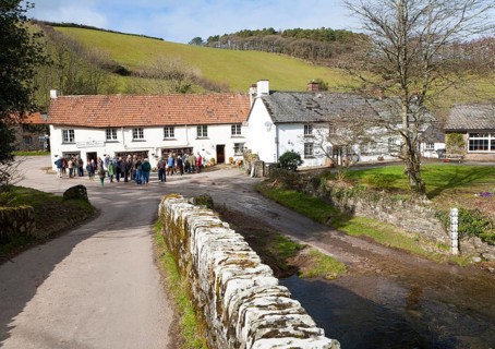Groups of people outside Lorna Doone Farm, Malmsmead, Exmoor national park, Devon, England, United