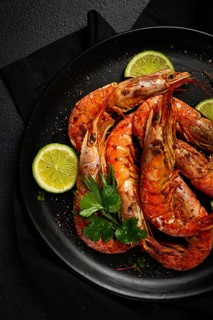 Langoustines, Australian, freshly frozen on ice, top view, lime and greens