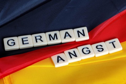 Symbolic image of German Angst: letter cube on a German flag