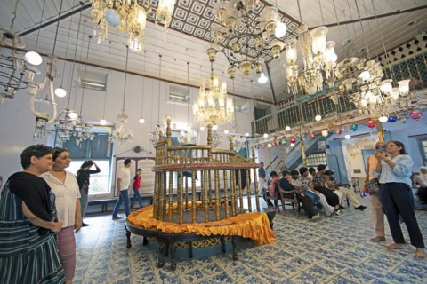 Indian visitors in the interior of the Paradesi Synagogue, Matancherry, Jewish Town, Kochi, Kerala,