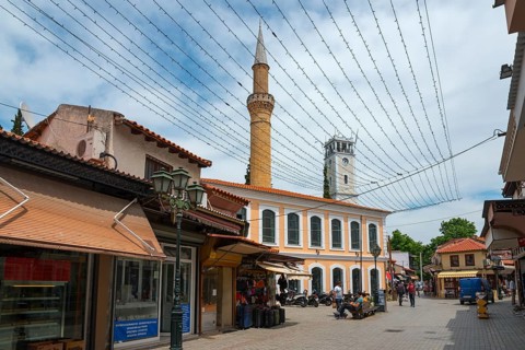 Tourist street with a minaret and shops under a network of fairy lights, New Mosque and Clock