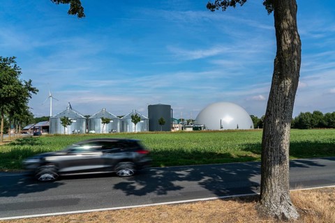 Biogas plant, storage silos, large buffer tank for hot water for intermediate energy storage,