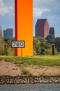 The sculpture Rhine Orange at the mouth of the Ruhr into the Rhine, skyline of the city centre of