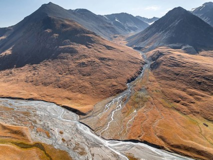 Aerial view, Burkhan mountain valley with meandering river, barren dramatic mountain landscape,