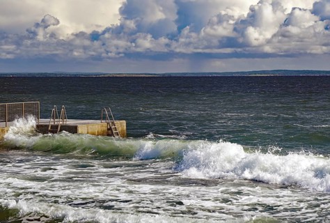 Huge waves crash against a jetty under a dramatic sky, Tönsberg, Oslofjord, Norway, Europe