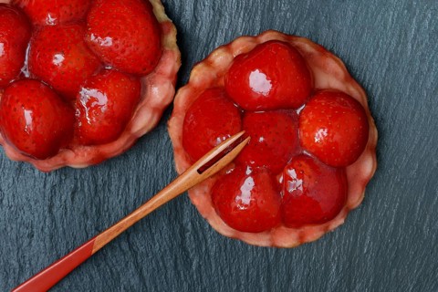 Topped strawberry tarts with a fork