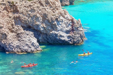 Group of people Kayaking, Tsigrado, Milos Island, Cyclades Islands, Greece, Europe