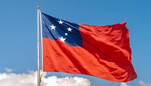 The flag of Samoa, fluttering in the wind, isolated against a blue sky