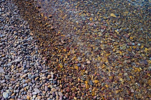 Colourful pebbles on the beach with water and different textures, Lambi beach, pebble beach,