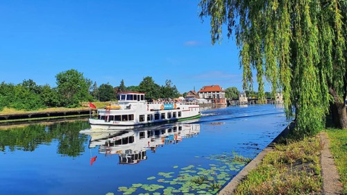 An excursion boat sailing on a calm river on a sunny day, Birkut ship, Elblag River, Elblag,