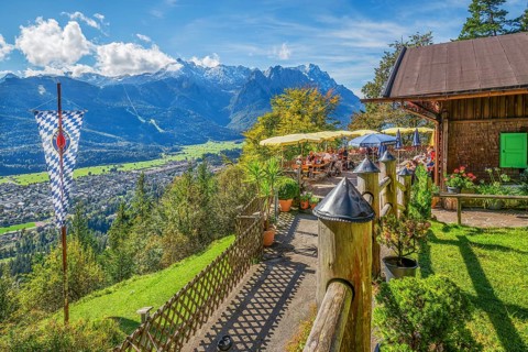 St. Martinshütte with restaurant terrace above the valley in front of the Zugspitze group 2962m,