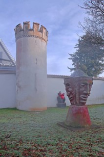 Sculptures by Helmut Braig and Bocksturm built in the 16th century with historic town wall, modern
