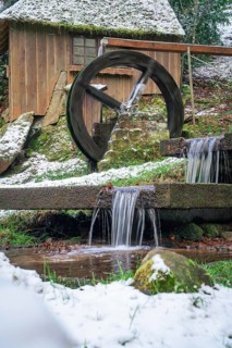Wooden water mill with running water, snow covers the surroundings, spa gardens, Bad Wildbad, Black