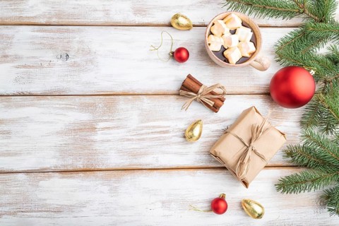 Christmas or New Year composition. Decorations, box, red balls, cinnamon, fir and spruce branches,