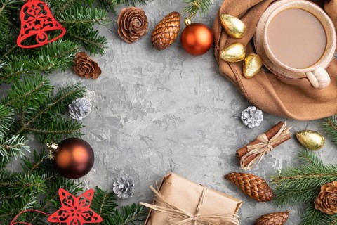Christmas or New Year frame composition. Decorations, cones, cinnamon, fir and spruce branches, cup